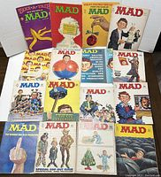 Photo showing full lot of 16 Mad Magazines with front covers visible.