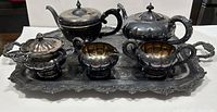 Complete silver-plated tea set arranged on the large serving tray showing all items included in the lot.