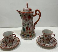 Full set photo showing the vintage hand painted Japanese tea pot with matching two teacups and saucers, decorated with detailed Geisha and flower garden designs.