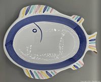 Top view showing the multicolor fish design on the platter's front surface.
