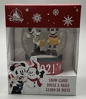 Photo of boxed Disney 2021 Holiday Snow Globe with Mickey and Minnie inside, showing packaging and item details.