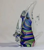 Clear glass fish figurine with multicolor striped pattern in the body