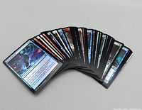 Image of Magic The Gathering cards fanned out showing front artwork and card text.