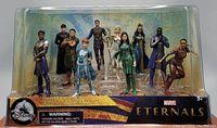 Front view of the boxed set showing all 10 Eternals figurines displayed in two rows inside clear plastic packaging with Disney and Marvel Eternals branding.
