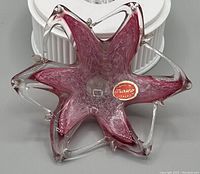 Top-down view showing the pink flower shape and textured swirl glass pattern with clear glass petal edges and sticker.