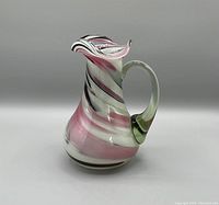 Front angled view of the vintage Murano glass swirl pitcher showing body shape, handle and wavy rim