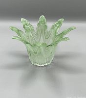 Front angle view of the green blown glass flower vase showing the flared petal design.