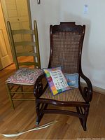 Rocking and ladderback chairs together with pillows showing overall condition