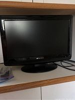Front view of the Sansui 18-inch television showing the screen and stand base.