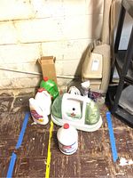 Lot contents including Hoover steam vac, Bissell Little Green cleaner, and cleaning liquids in bottles