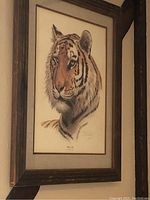 Frontal view of the framed Siberian Tiger print hung on the wall showing the overall presentation and condition of the artwork.