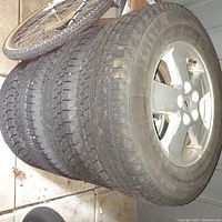Set of four winter tires mounted on silver factory 5-spoke rims for Ford Escape.