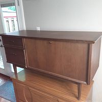Front and side view of the custom wooden chest showing two drawers on left side and hinged top panel