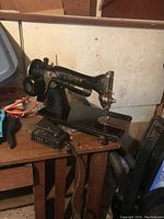 Full side view of antique Singer electric sewing machine showing motor, light, and base condition