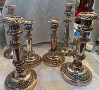 Photo showing all six antique Old Sheffield Plate candle sticks in three different paired designs.