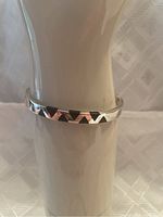 Bracelet 1: slim bangle with raised triangle motif