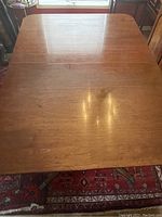Top view of the rectangular mahogany dining table surface showing the finish and size.