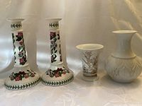 Photo showing one pair of Portmeirion Botany Garden floral candlesticks, one small Kaiser Atlantis vase, and one white KPM Royal Porzellan Bavaria vase