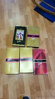 Top view of all 5 Barbie dolls in original boxes arranged on floor to show variety and packaging condition