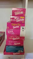 Stack of 6 Barbie doll boxes showing various editions including Fifties Fun Barbie and Jewel Hair Mermaid.