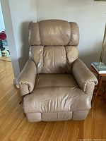 Front view of the brown leather La-Z-Boy rocker recliner chair showing overall shape and condition.