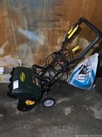 Photo showing side view of YardWorks electric snow thrower with cord and controls on handlebar