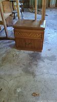 Front view of Kroehler wood nightstand showing top surface and two drawer fronts with golden knobs.