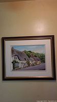 Full frontal photo of original acrylic painting showing the country cottages framed on wall.