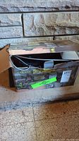 Box packaging showing Trakker 3000 lb winch branding and indication of 50 ft galvanized wire rope and 12V DC operation.