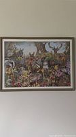 Framed print showing a colorful woodland wildlife scene under a large tree, animals grouped naturally around flowers and greenery.