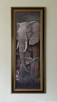 Full view of the framed elephant and baby print showing the detailed artwork and frame style.