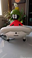 Front view of vintage Marvin the Martian phone with Toshiba logo and handset in front of Marvin figure.