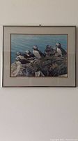 Full view of framed artwork showing Atlantic Puffins near ocean.