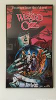 Full view of the framed The Wizard of Oz movie poster showing main characters and title.