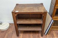 Photo of oak Mission style double-sided bookcase with open door revealing shelves