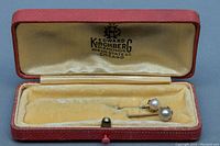 Two antique 9K gold stick pins with pearls in original Edward Kirchberg red jewelry box with velvet lining.