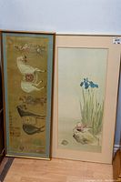 Photo showing two framed Chinese prints side by side; left with horse and attendants, right with birds and irises.