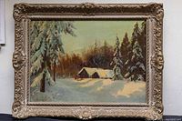 Full view of the framed oil painting showing a winter landscape with snow-covered trees and cabins.