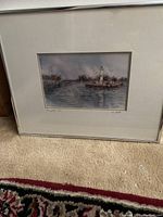 Framed artwork showing lighthouse scene with matting and frame detail