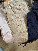 Three pairs of pants - one khaki, one navy and one sage with convertible zippers