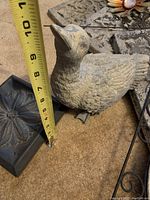 Close-up showing grey duck garden statue about 7 inches tall with detailed feather texture