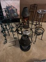 Overview of all metal outdoor accessory items including candle holders, plant holders, and decorative lanterns.