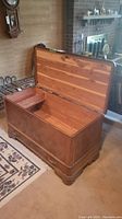 Open cedar chest showing interior and small compartment.