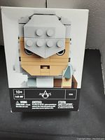 Front view of the sealed box showing the blocky figure's face with the label indicating 142 pieces and age 10+.