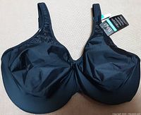 Front view of the black Bali minimizer bra showing smooth fabric and floral lace detail near straps.