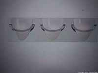 Front view of Eurofase Forma 3-light bathroom vanity light showing semi-circular opal silk glass shades mounted on polished chrome rectangular base.