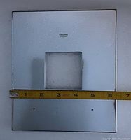Front view of the Grohe shower plate with measuring tape showing about 7 inches width.