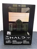 Front view of the sealed buildable figure box showing Master Chief face design, Halo and Mega Bloks branding, 147 pieces count, and age recommendation 10+