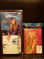 Photo of the Hannah Montana removable wall decorations and personalized diary book in packaging, showing front designs.