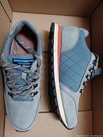 Pair of women's L.L. Bean sneakers size 9 Medium shown side profile in box.